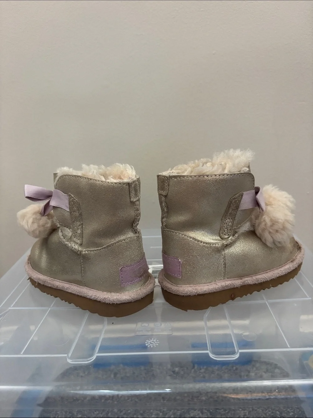 UGG Kids Metallic Gold Pom-Pom Boots with Pink Ribbon